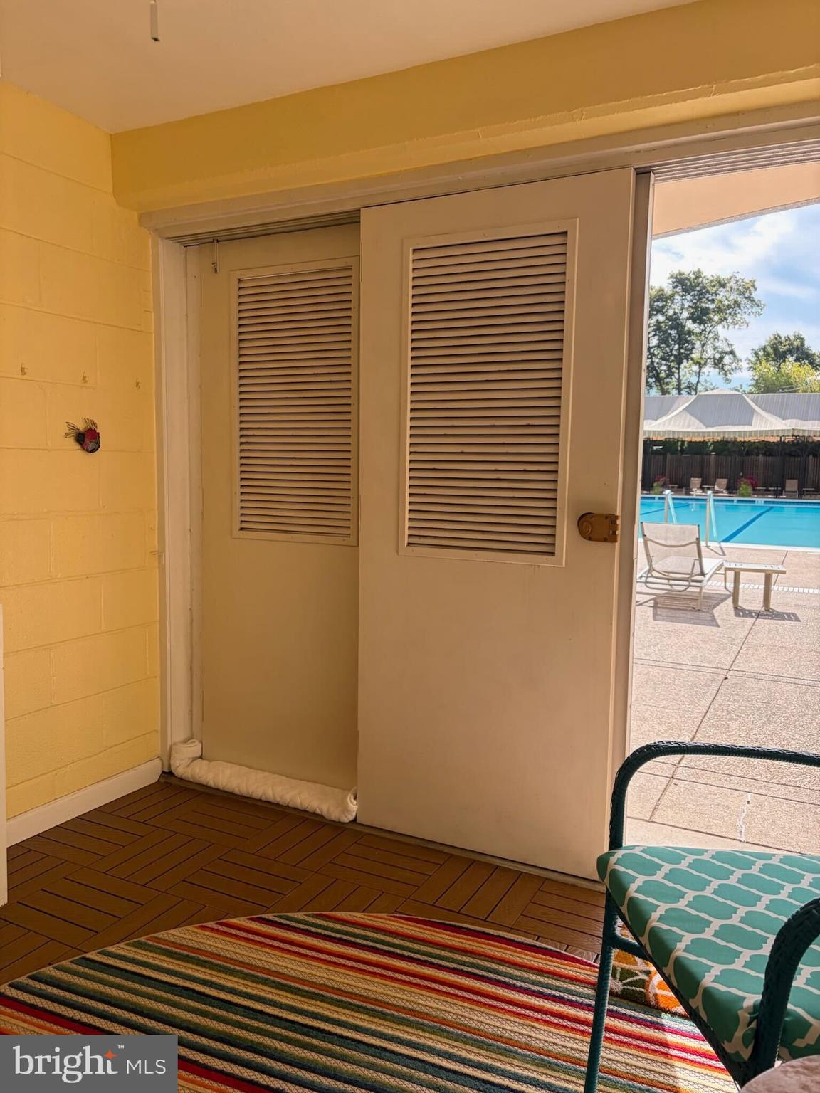 2801 New Mexico Avenue Northwest, Unit 204 Washington, DC 20007 - Photo 32 of 49 a view of a bedroom with wooden floor and a balcony