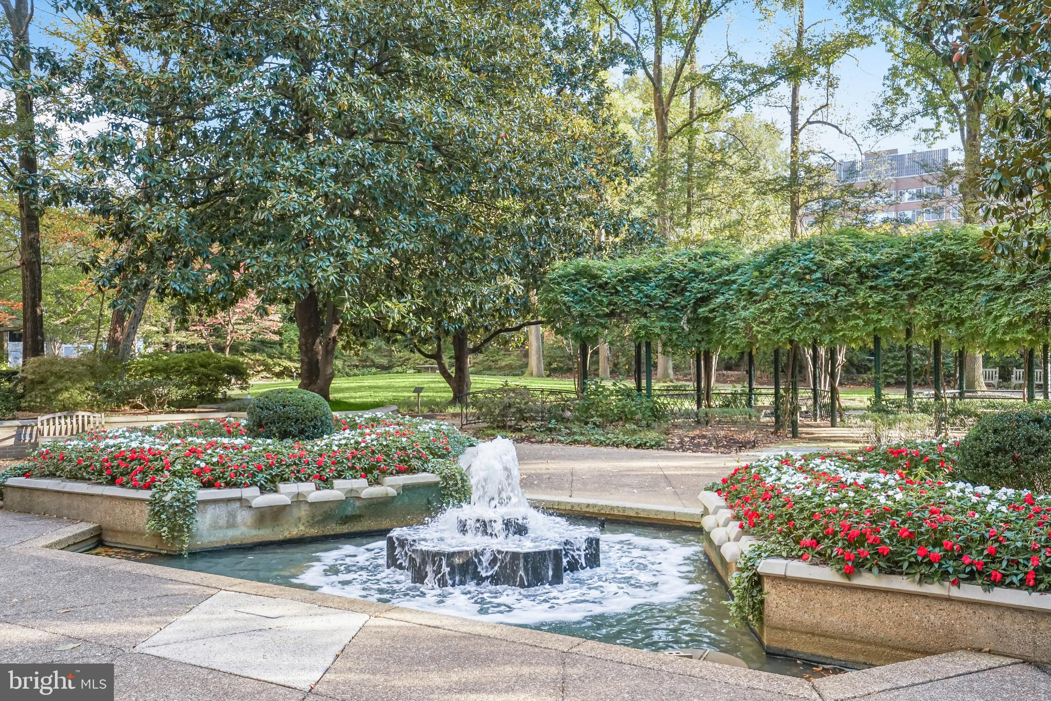 2801 New Mexico Avenue Northwest, Unit 204 Washington, DC 20007 - Photo 46 of 49 a front view of a house with a yard and fountain in middle