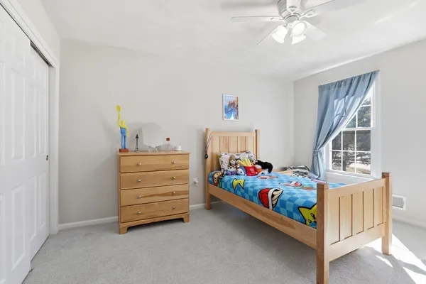 a bedroom with furniture and a baby crib