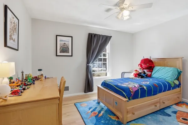 a bedroom with a bed and a chandelier