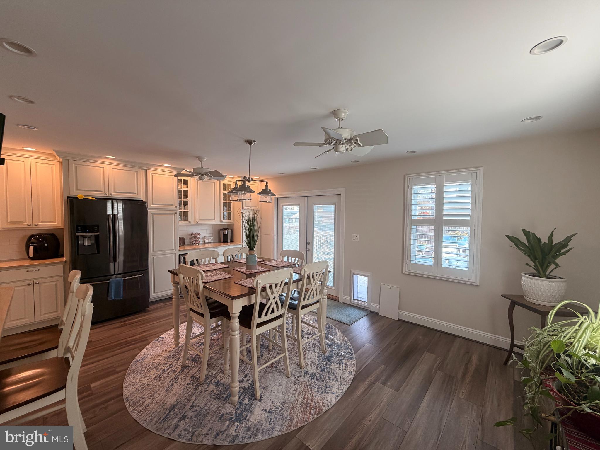 1705 Fairhill Drive Edgewater, MD 21037 - Photo 12 of 36 a dining room with furniture a chandelier and wooden floor