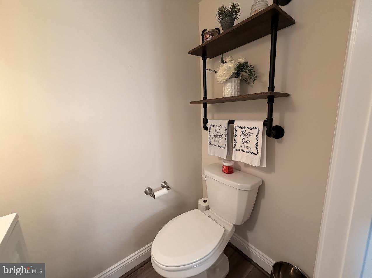 1705 Fairhill Drive Edgewater, MD 21037 - Photo 8 of 36 a white toilet sitting next to a bathroom sink and vanity