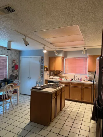 a kitchen with stainless steel appliances a stove a sink dishwasher and a refrigerator