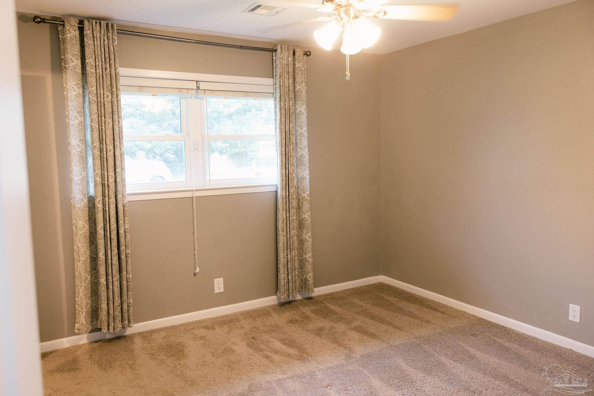 5580 Homewood Road Pensacola, FL 32504 - Photo 17 of 28 an empty room with a window