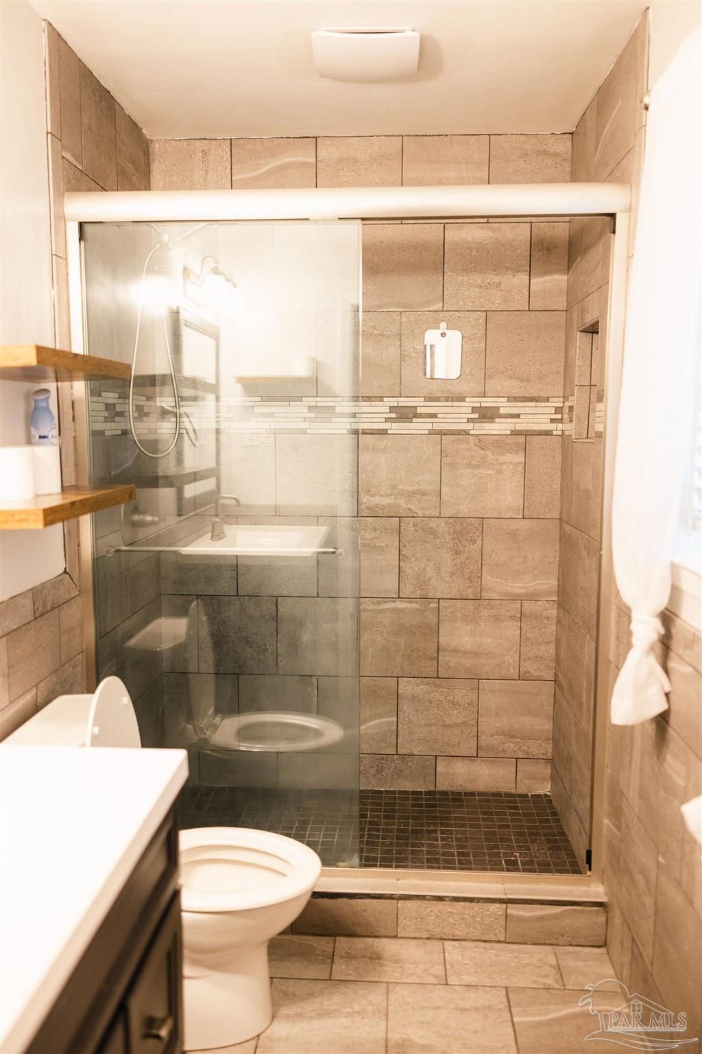 5580 Homewood Road Pensacola, FL 32504 - Photo 19 of 28 a bathroom with a shower and a toilet