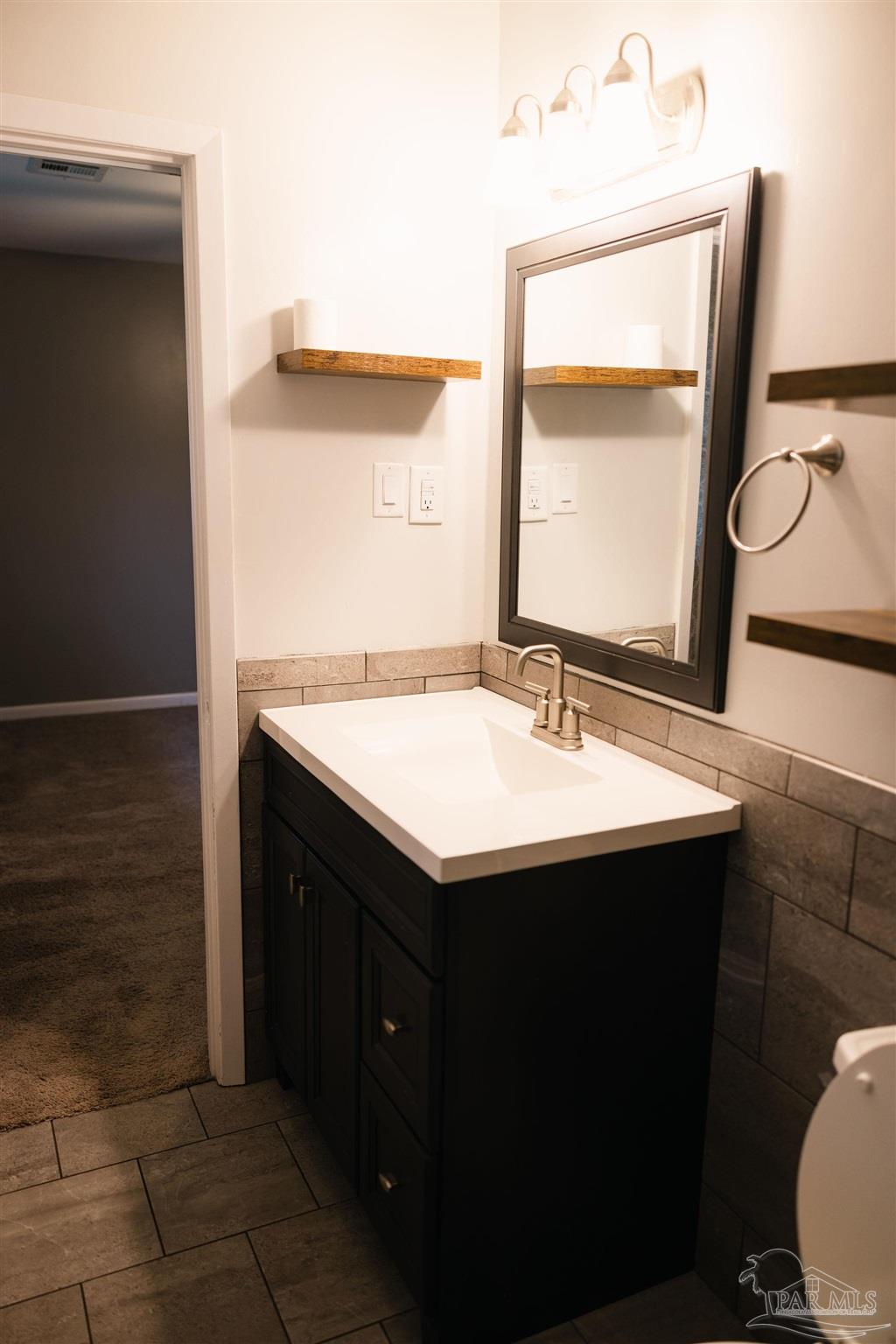 5580 Homewood Road Pensacola, FL 32504 - Photo 20 of 28 a bathroom with a sink and a mirror