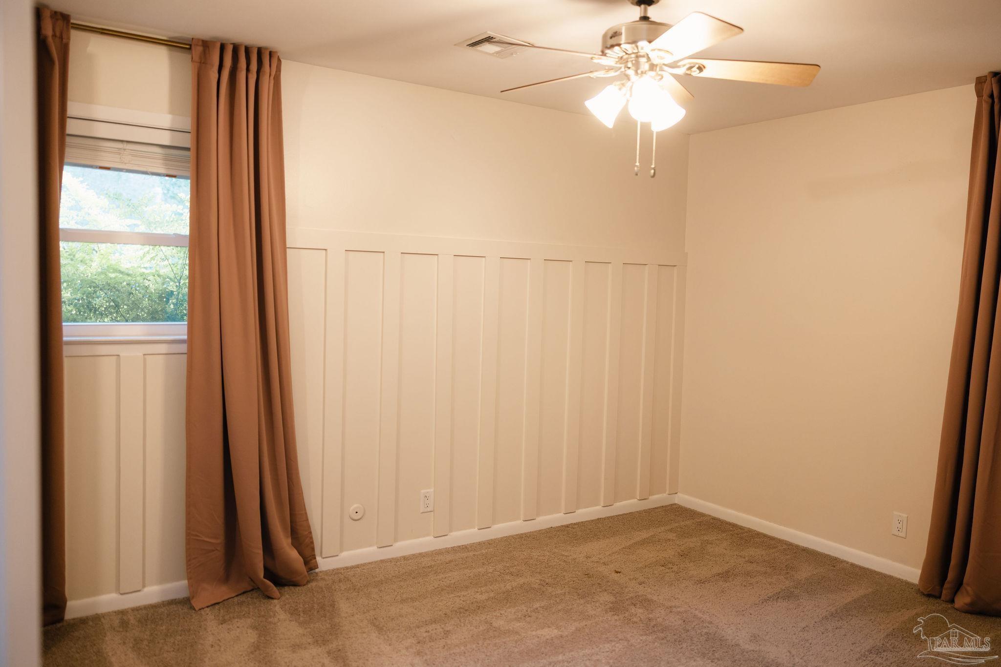 5580 Homewood Road Pensacola, FL 32504 - Photo 21 of 28 an empty room with windows and fan