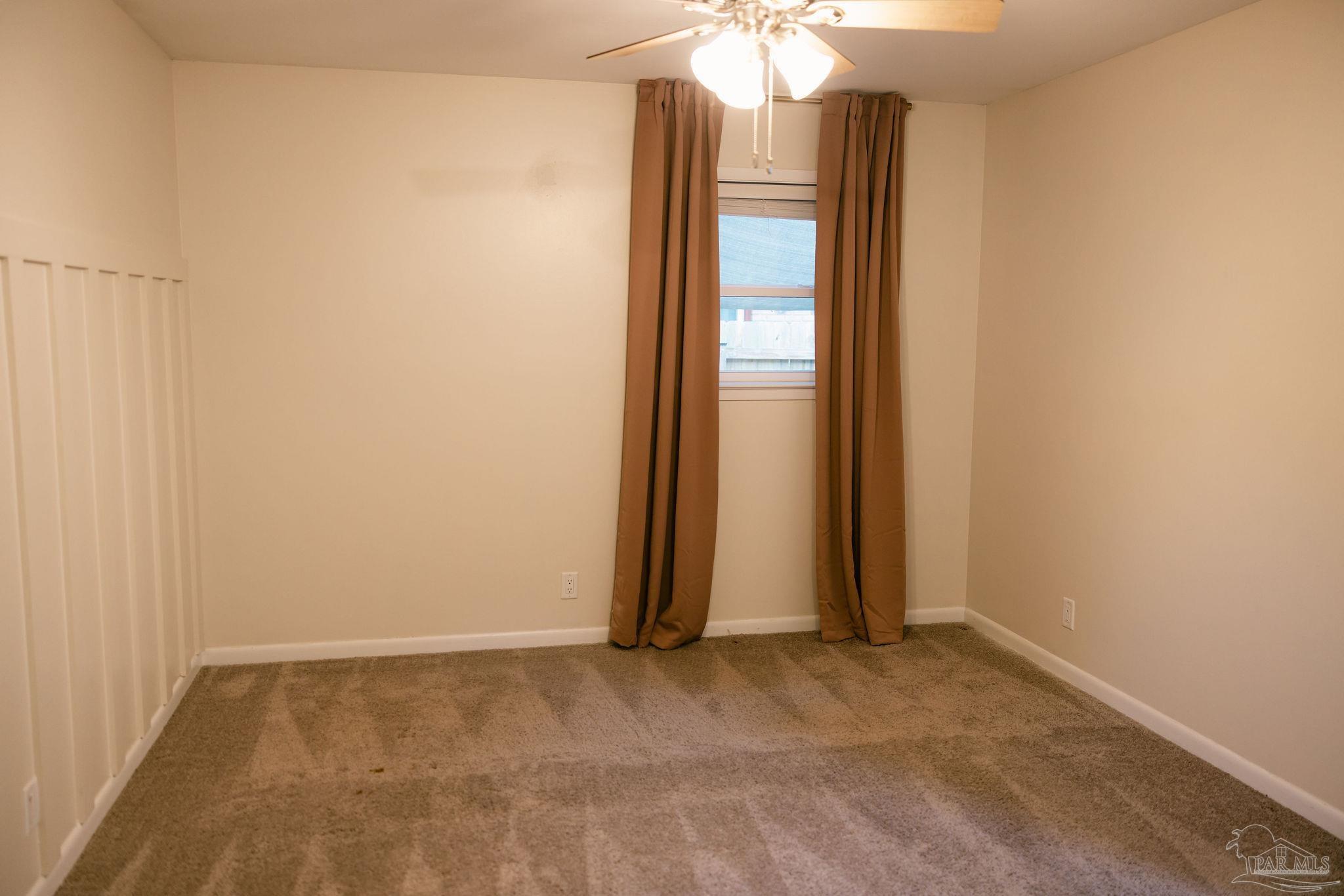 5580 Homewood Road Pensacola, FL 32504 - Photo 23 of 28 an empty room with stairs and wooden floor