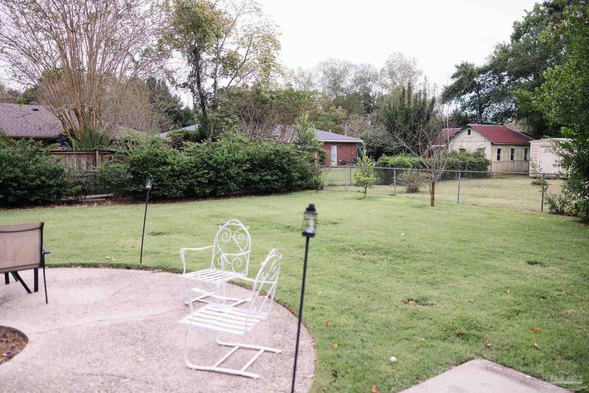 5580 Homewood Road Pensacola, FL 32504 - Photo 27 of 28 a garden with trees in front of it