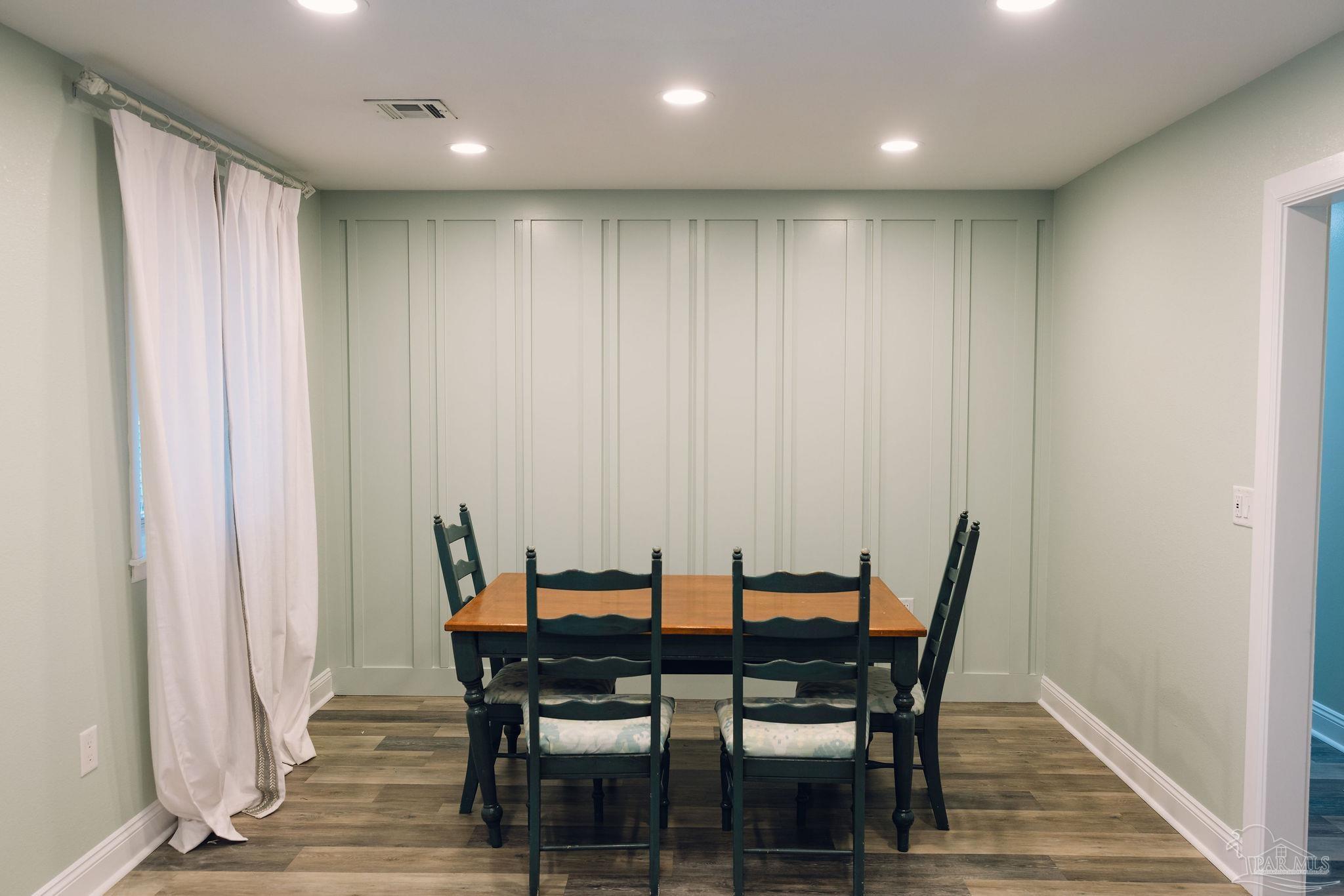 5580 Homewood Road Pensacola, FL 32504 - Photo 3 of 28 a view of a dining room with furniture and wooden floor