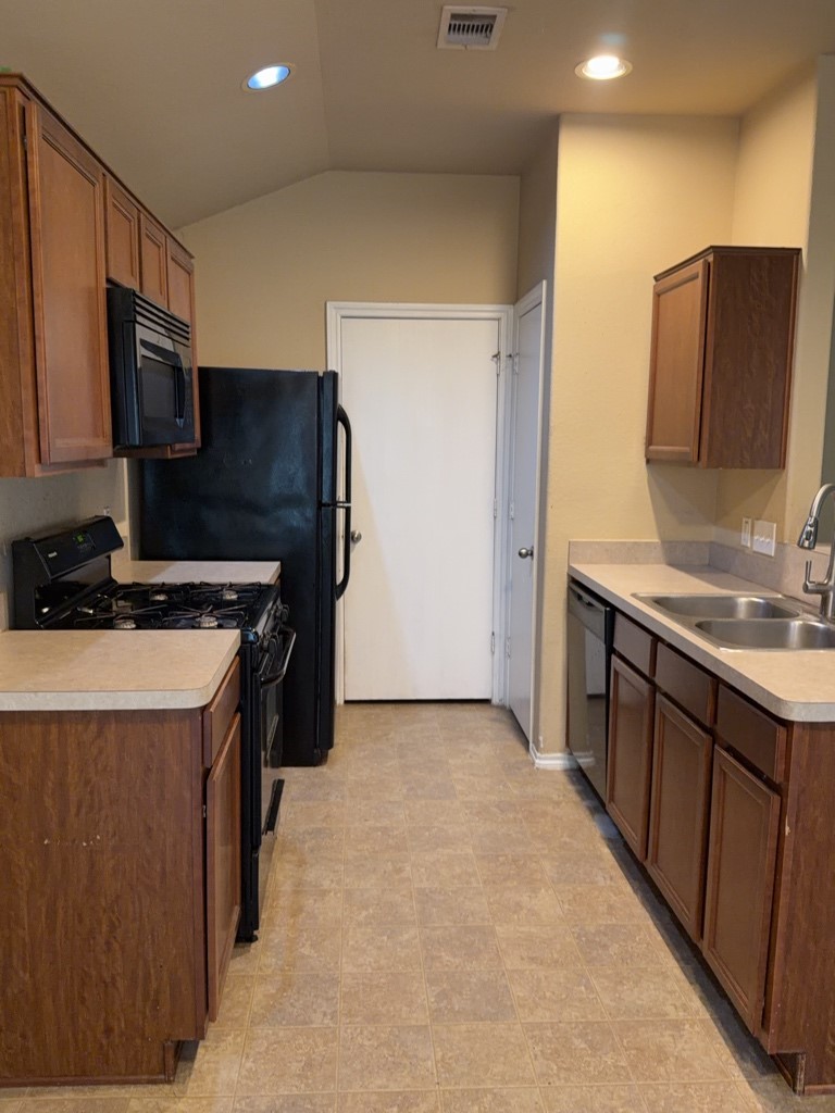 811 Lovebug Lane Conroe, TX 77301 - Photo 5 of 9 a kitchen with stainless steel appliances a refrigerator and a stove