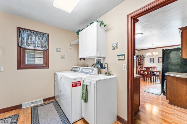 197 Mathews Road, Unit A Youngstown, OH 44512 - Photo 21 of 32 Laundry room featuring cabinets, independent washer and dryer, light hardwood / wood-style floors, a chandelier, and ornamental molding