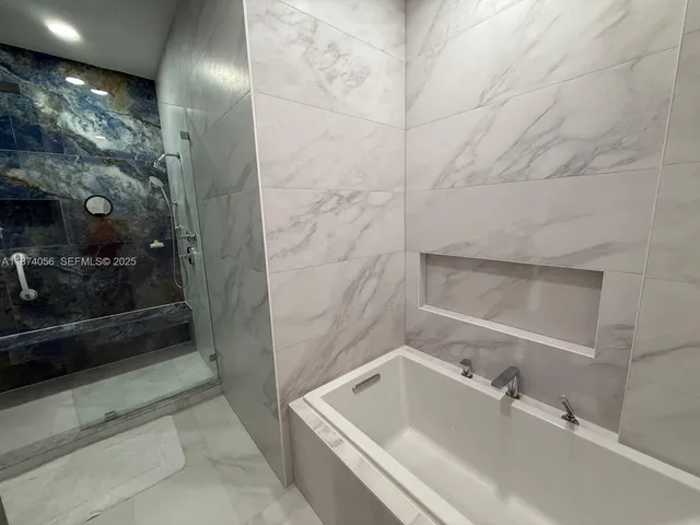 a bathroom with a granite countertop sink toilet and mirror