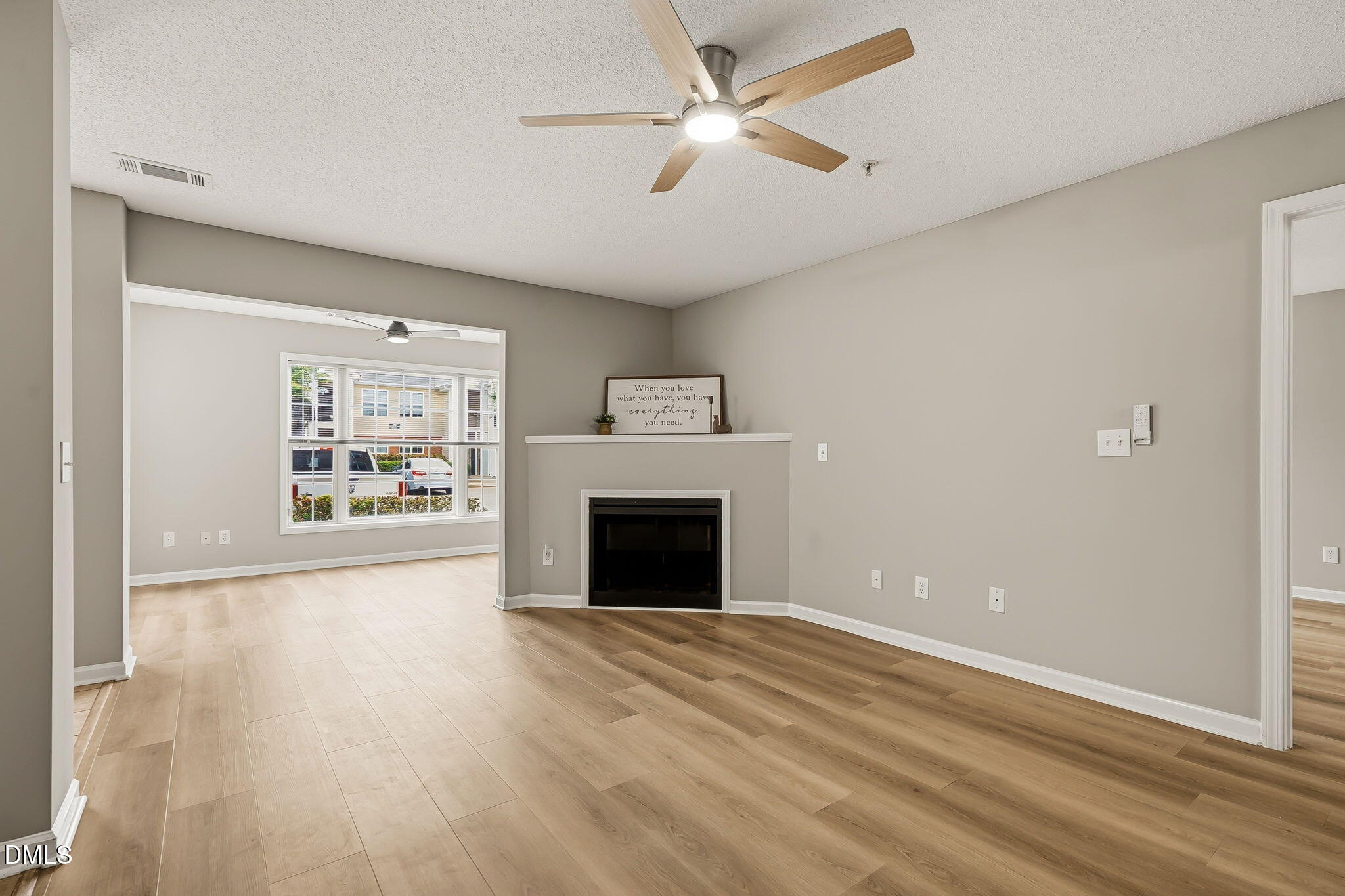 2501 Huntscroft Lane, Unit 100 Raleigh, NC 27617 - Photo 16 of 31 wooden floor fireplace and windows in an empty room