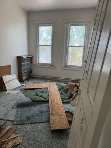 a bedroom with bed and window