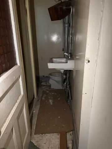 a bathroom with a sink a toilet and mirror
