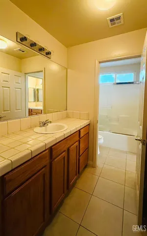 a bathroom with a granite countertop sink mirror and a