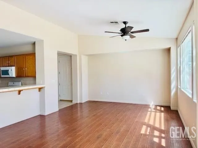 wooden floor in an empty room with a window
