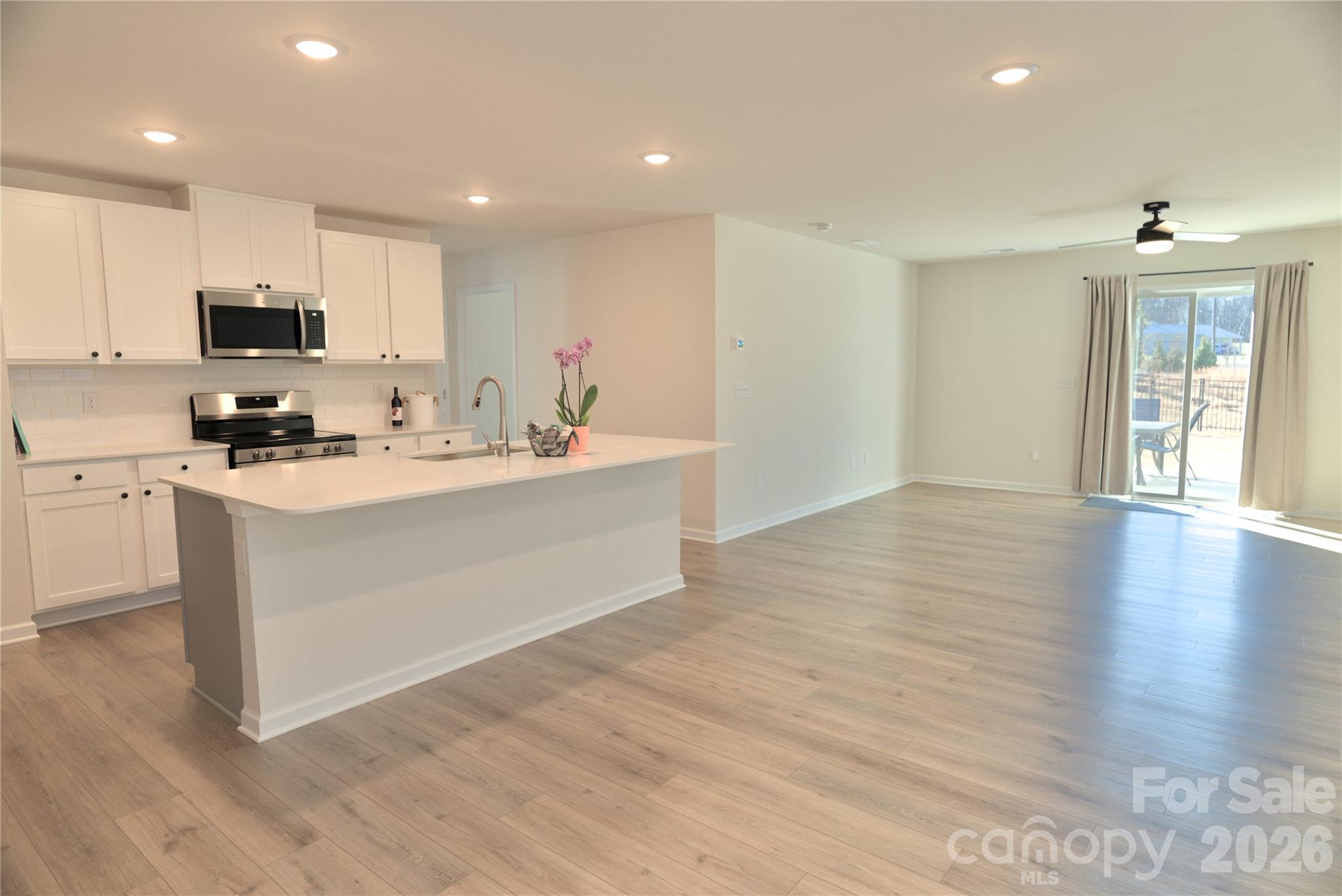 2154 Trollinger Drive Catawba, NC 28609 - Photo 5 of 33 a white kitchen with wooden floor and stainless steel appliances