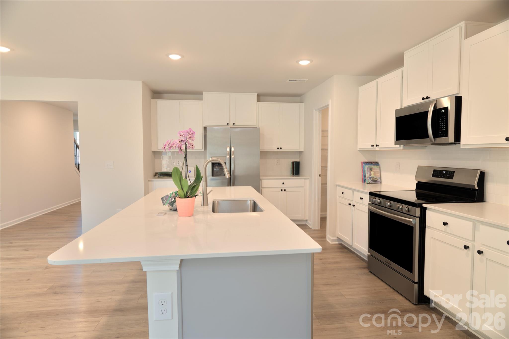 2154 Trollinger Drive Catawba, NC 28609 - Photo 7 of 33 a kitchen with kitchen island a sink stove and refrigerator