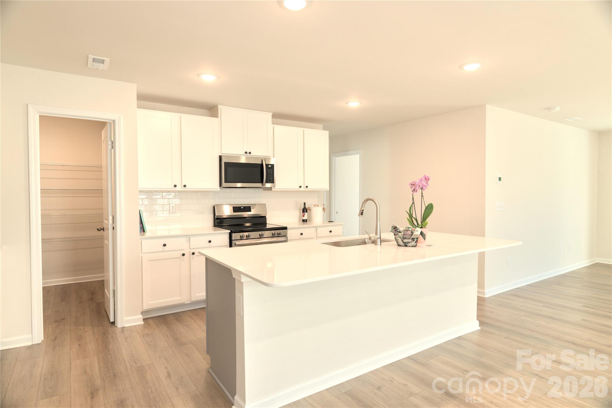 2154 Trollinger Drive Catawba, NC 28609 - Photo 8 of 33 a kitchen with a sink a stove a refrigerator a center island and cabinets