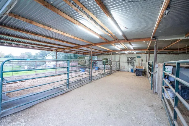 a living room with furniture a flat screen tv and kitchen view