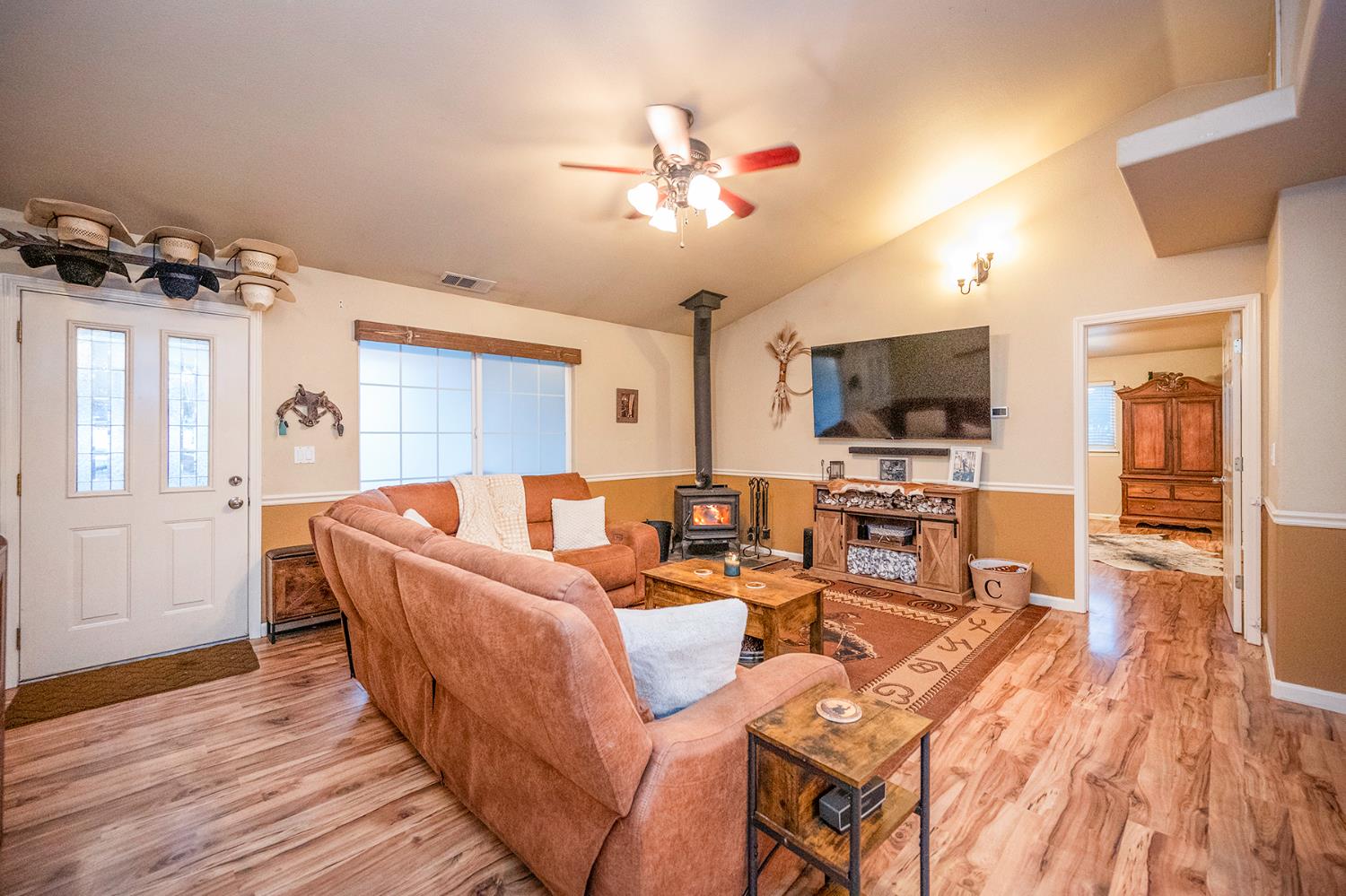 4568 Roadrunner Drive Ione, CA 95640 - Photo 14 of 56 a living room with furniture a flat screen tv and kitchen view