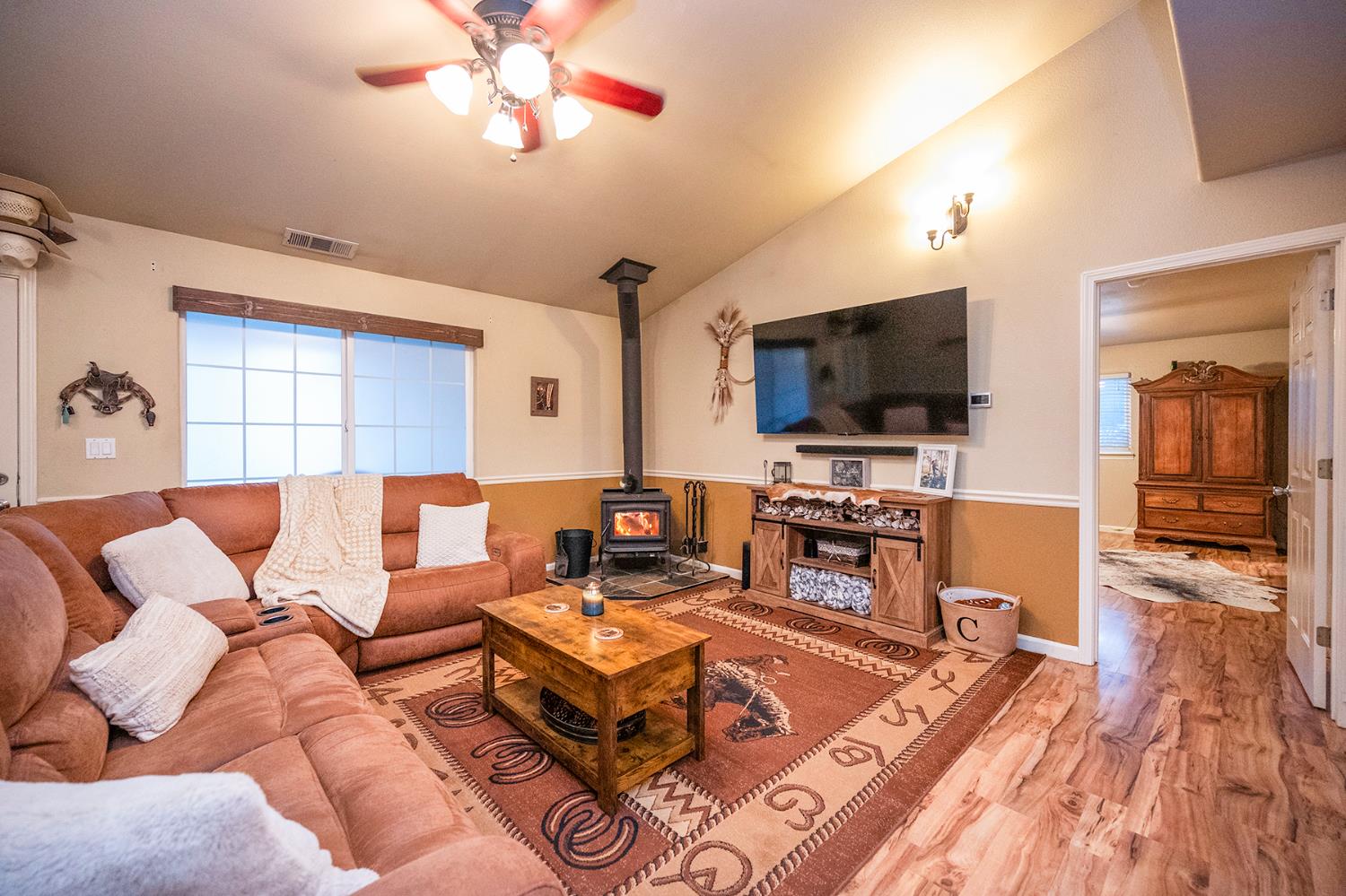 4568 Roadrunner Drive Ione, CA 95640 - Photo 16 of 56 a living room with furniture and a flat screen tv