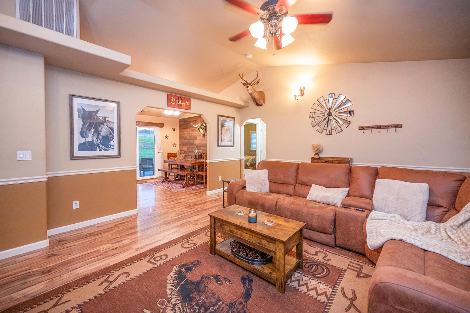 4568 Roadrunner Drive Ione, CA 95640 - Photo 19 of 56 a living room with furniture a couch and paintings on the wall