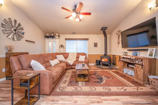 a kitchen with stainless steel appliances granite countertop a refrigerator stove top oven and cabinets