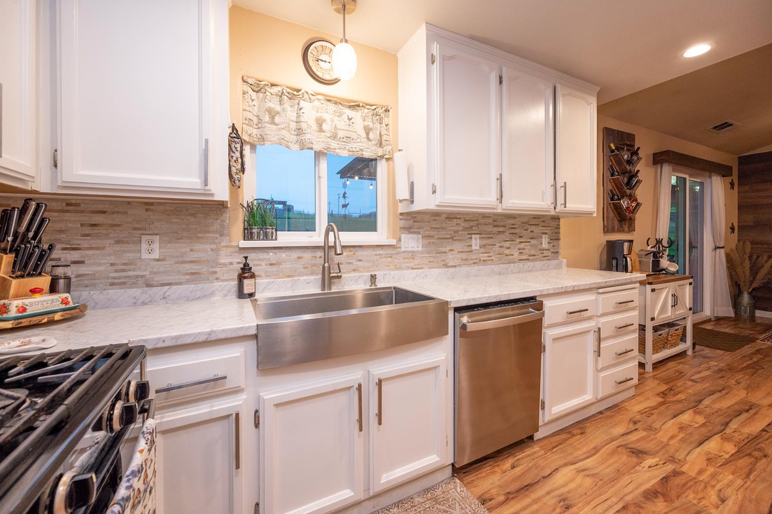4568 Roadrunner Drive Ione, CA 95640 - Photo 27 of 56 a kitchen with granite countertop a sink stainless steel appliances and cabinets