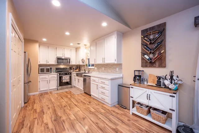 a very nice looking open dining room with kitchen island