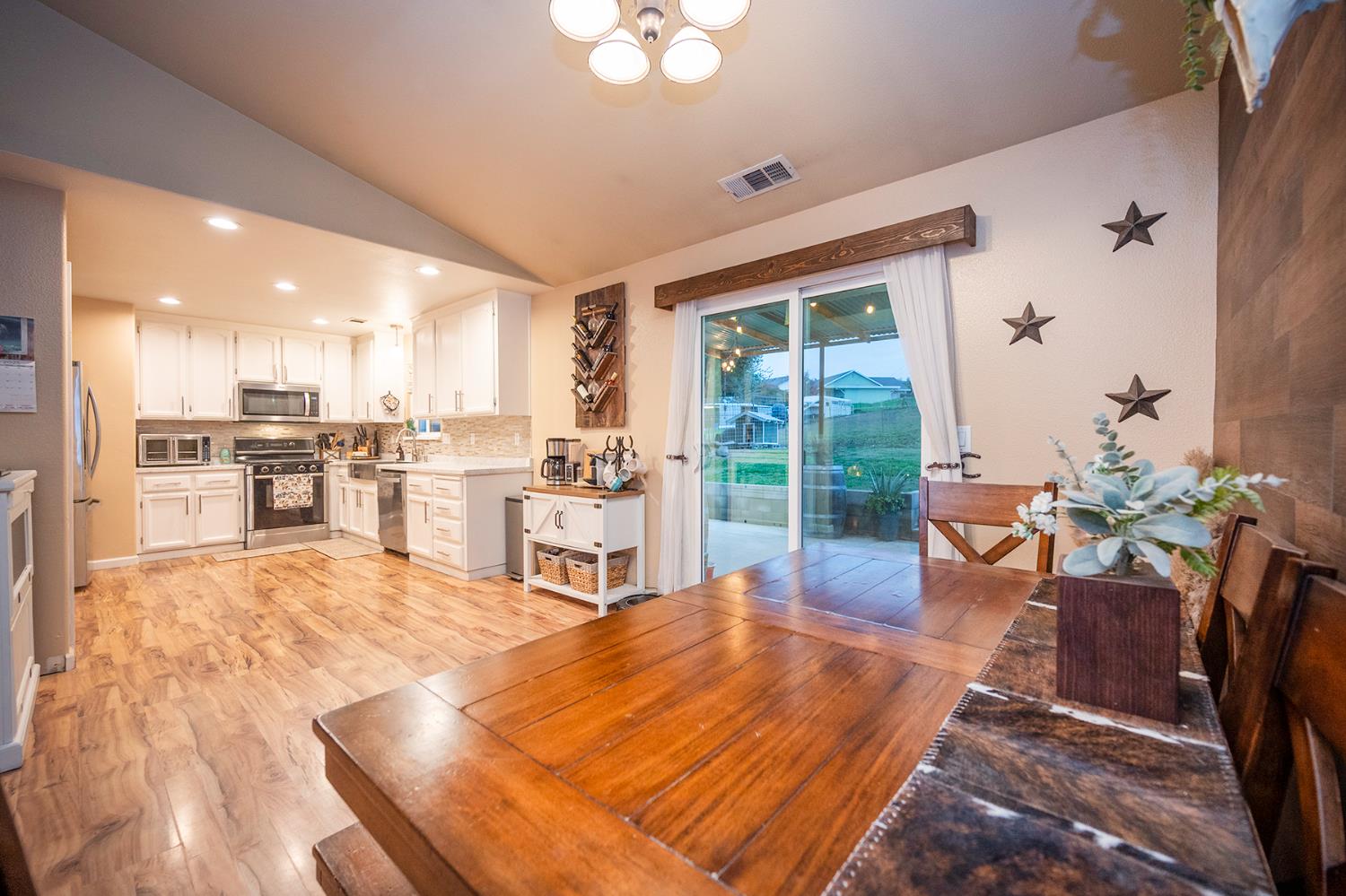 4568 Roadrunner Drive Ione, CA 95640 - Photo 31 of 56 a living room with furniture stove and kitchen view