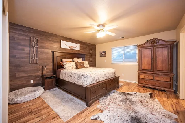 a bedroom with a large bed and a chandelier