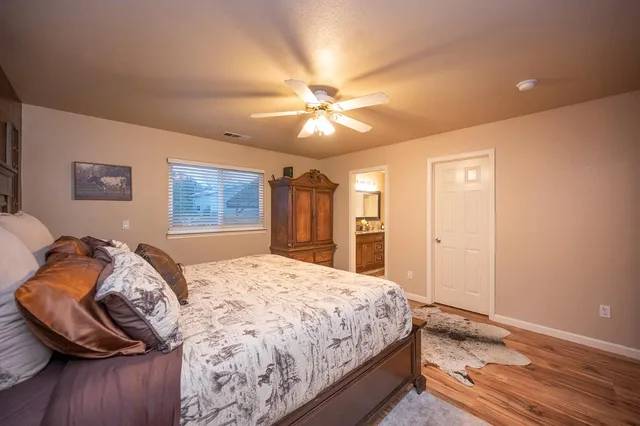a bedroom with a bed and a chandelier