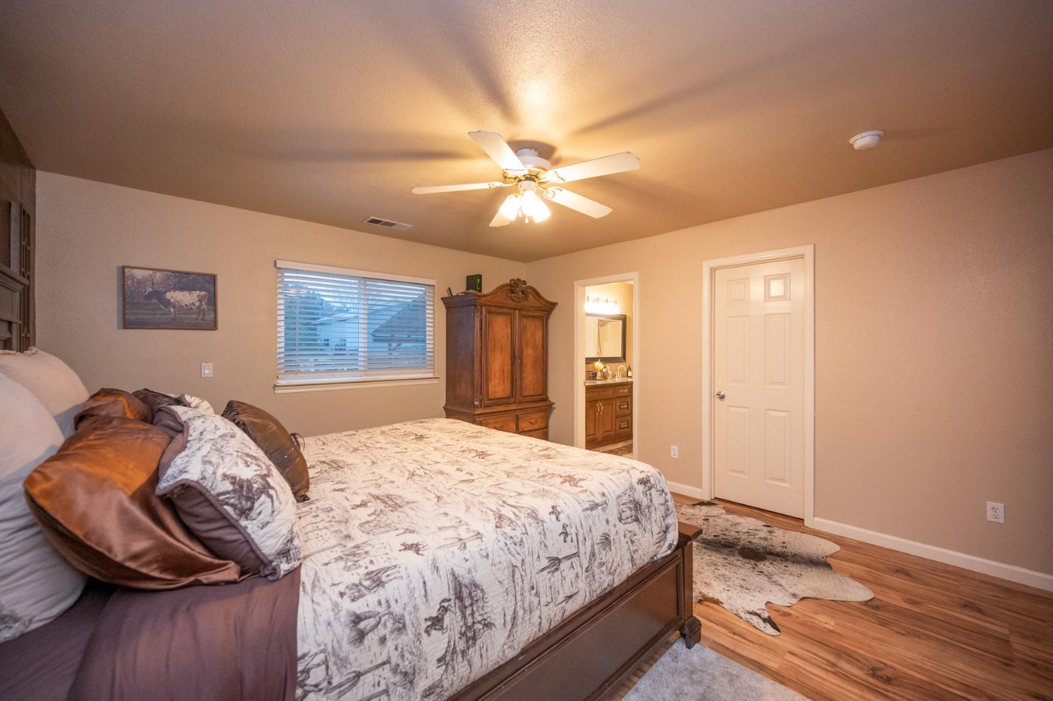 4568 Roadrunner Drive Ione, CA 95640 - Photo 35 of 56 a bedroom with a bed and a chandelier