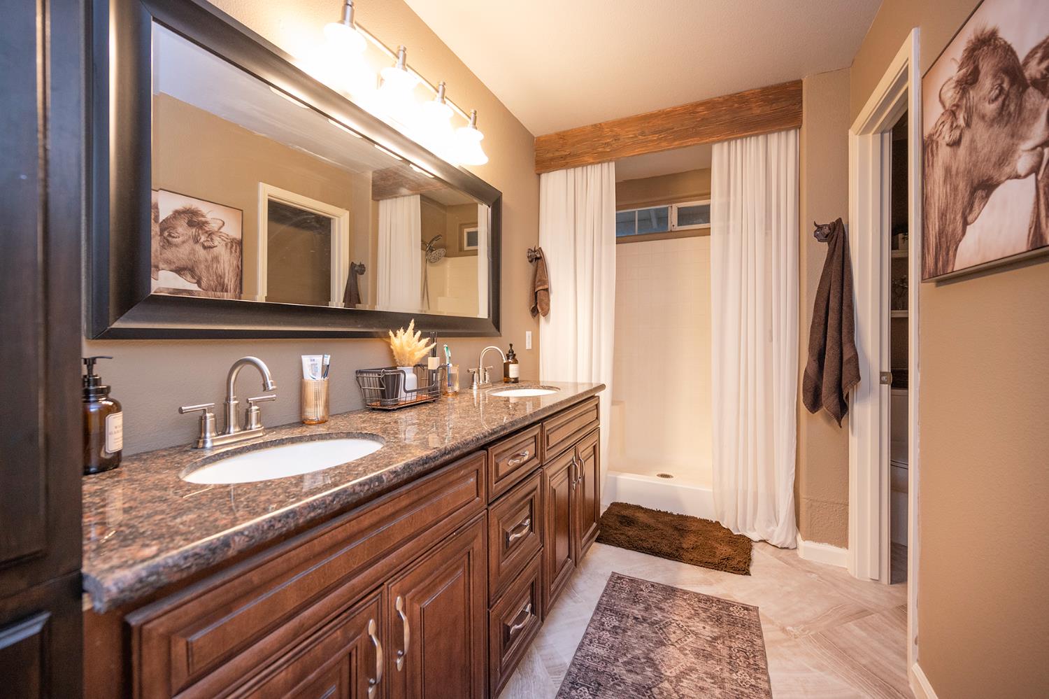 4568 Roadrunner Drive Ione, CA 95640 - Photo 36 of 56 a spacious bathroom with a granite countertop double vanity and a mirror