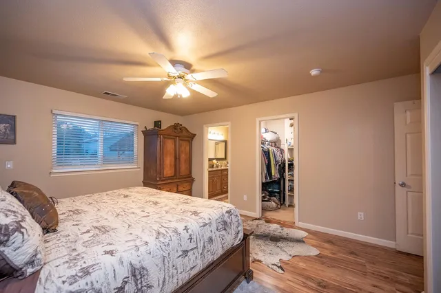 a bedroom with a large bed and a chandelier