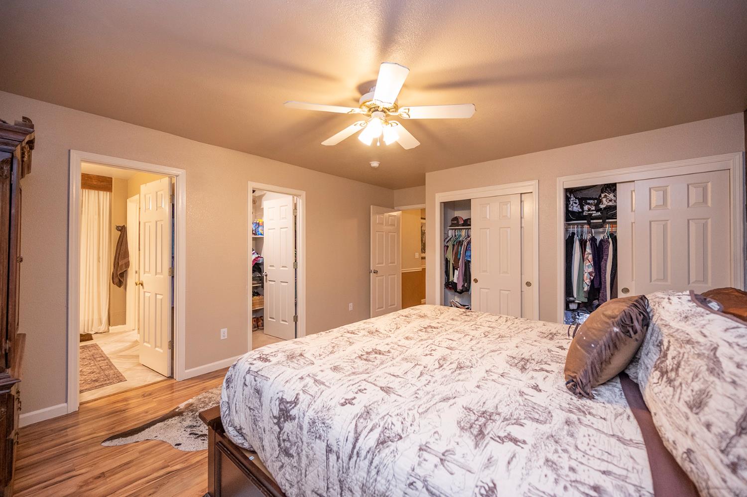 4568 Roadrunner Drive Ione, CA 95640 - Photo 39 of 56 a bedroom with a bed and a chandelier