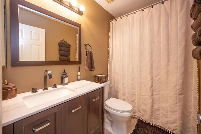 a view of a patio with dining table and chairs next to a yard