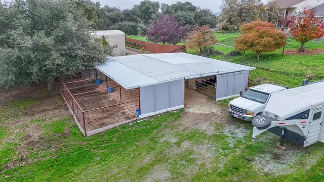 a view of a house with a yard and potted plants
