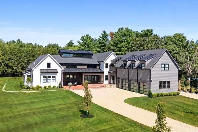 a front view of a house with a yard table and chairs