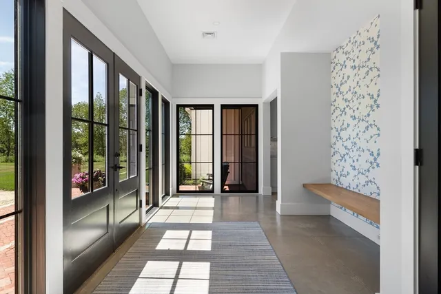 a view of hallway with furniture and a large window