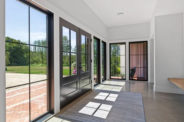 a view of a room with wooden floor and windows