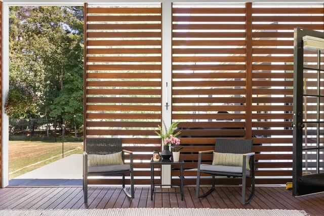 a view of a room with chairs and a rug