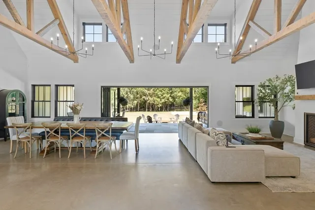 a living room with lots of furniture and a large window