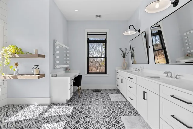 a bathroom with a double vanity sink mirror and bathtub