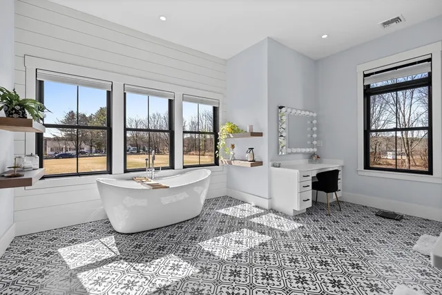 a living room with furniture and large windows