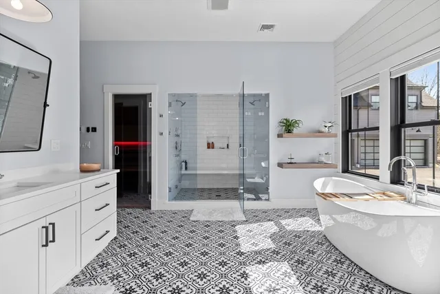 a large spacious bathroom with a double vanity sink a mirror and a bathtub