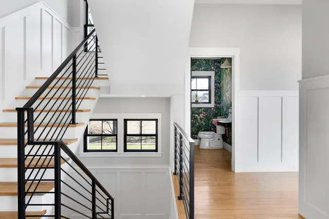 a view of entryway and hall with wooden floor